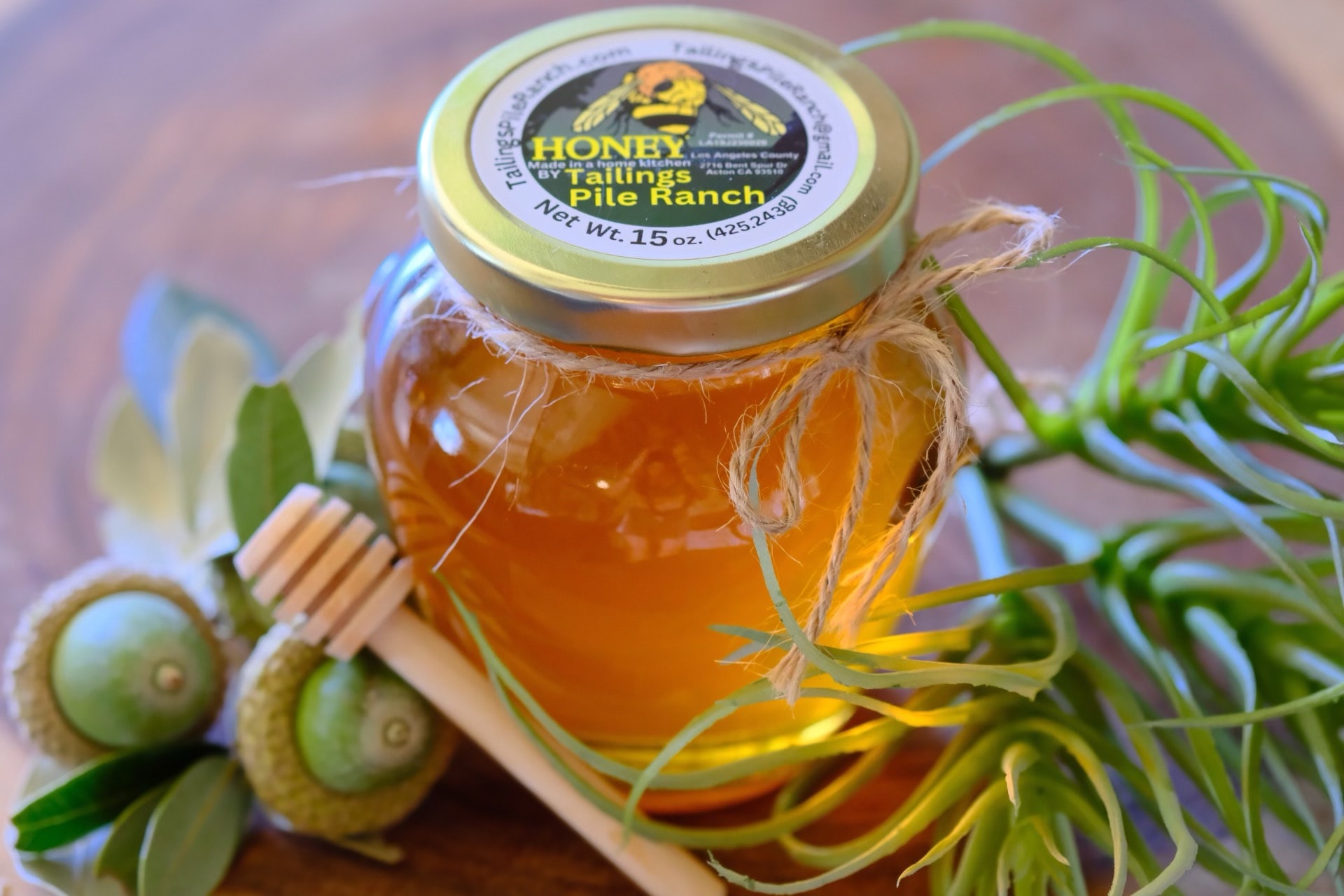 15 oz jar of Tailings Pile Ranch raw honey with honey dipper