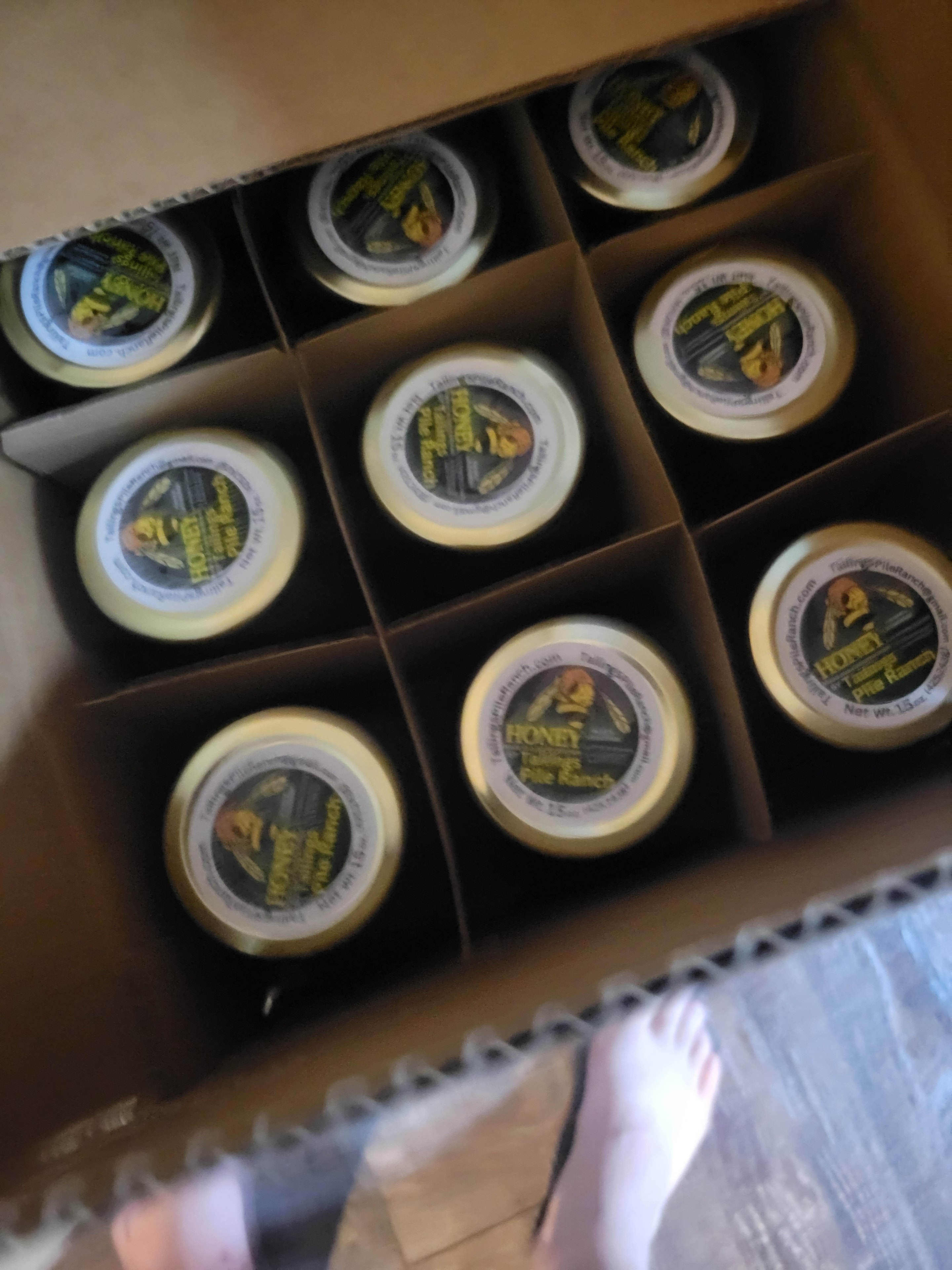 Box of Tailings Pile Ranch honey jars ready for pickup